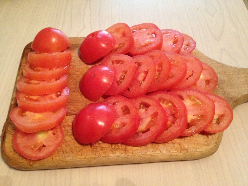 With each tomatoe, slice them into 1/2 an inch slices. Not too thin, but not too thick either, or they will burn easily, or take longer to cook.