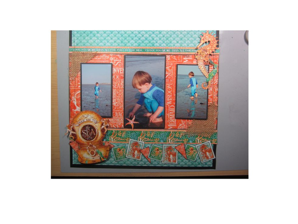 With foam tape I've add the sea helmet & sea horse. Don't be afraid to overlap on your pictures, as long as you're not blocking the main view. Then add your stamps and banners to the bottom.