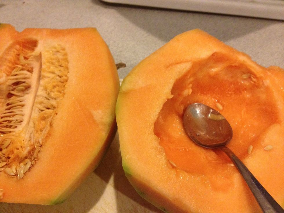 With Melon standing slice it into half. Gut the insides using a spoon
