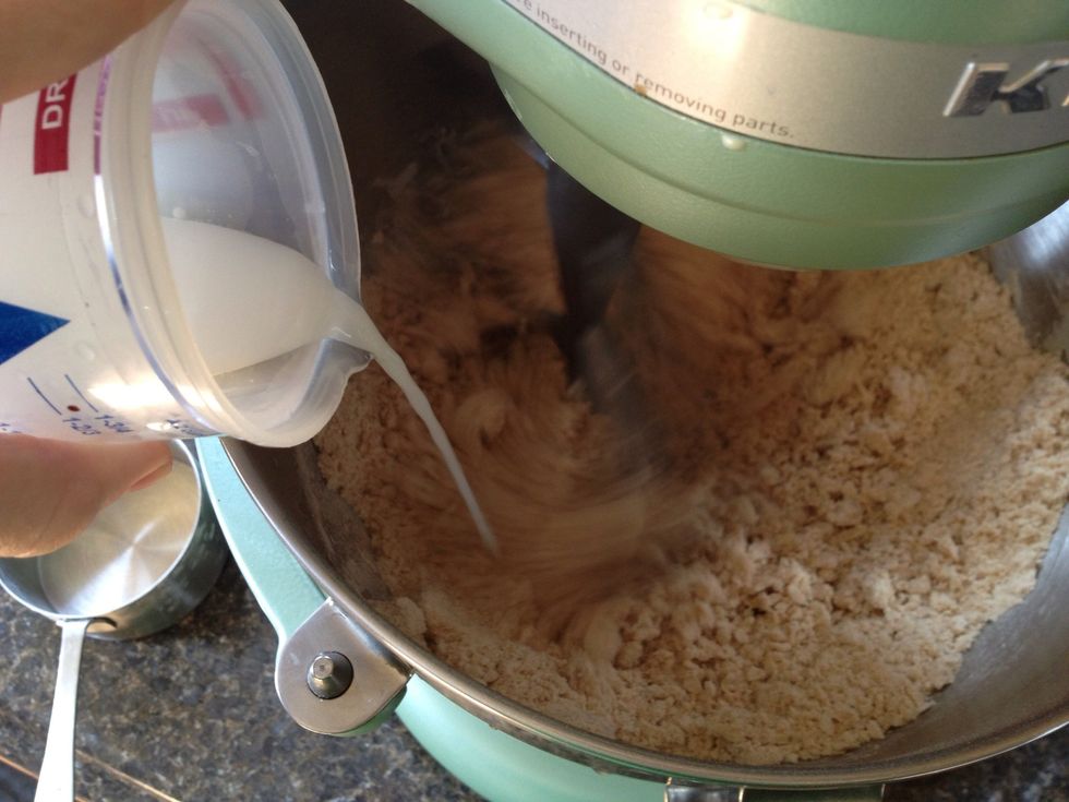 With mixer still on low, begin to pour in the water/milk mixture. Once all poured in, crank up the speed to medium to knead the dough.