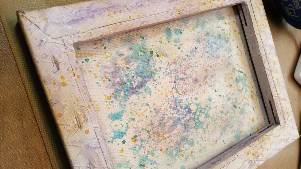 With my distess colored ink pad, I rub around the edges of the canvas and in a few of the lighter areas....to kiss it with a nice aged look.