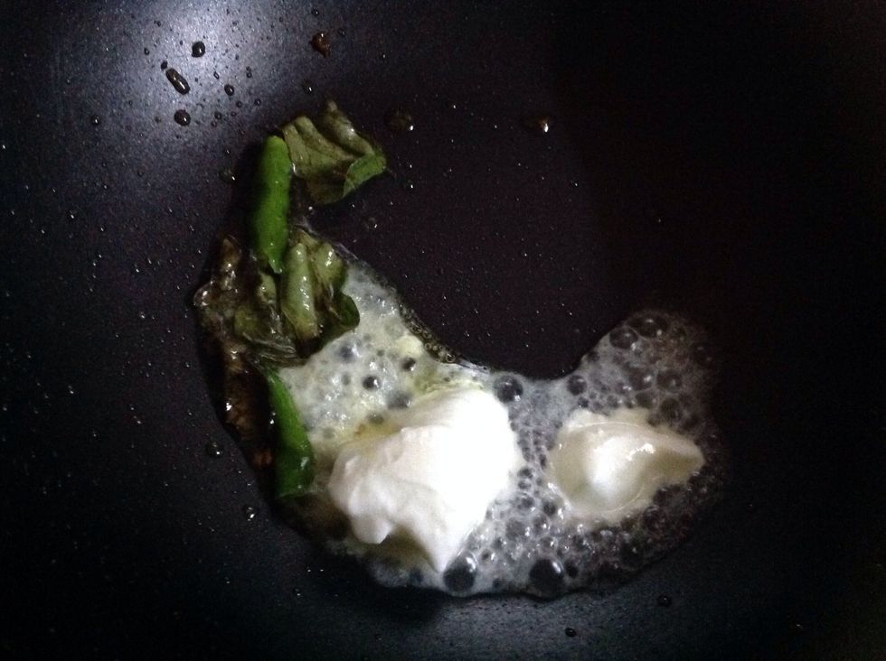 With olive oil,fry the curry leaves,green chilly and then add curd and cauliflower with it..