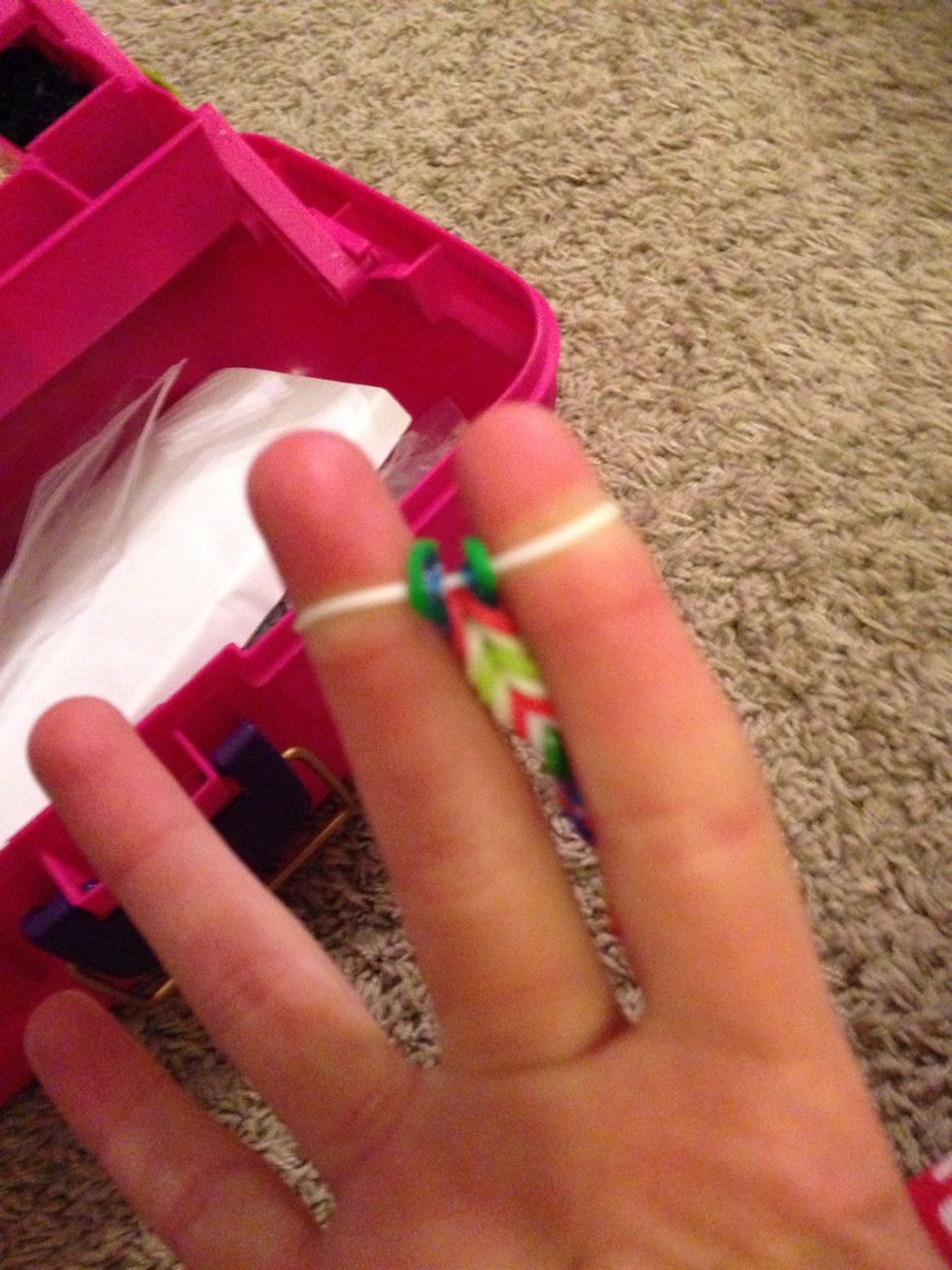 With out adding another rubber band on top loop up the bottom rubber band so it will look like this after wards