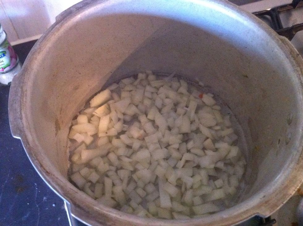 With pot on medium heat, add onions and cook for 7 to 8 mins (until onion is soft)