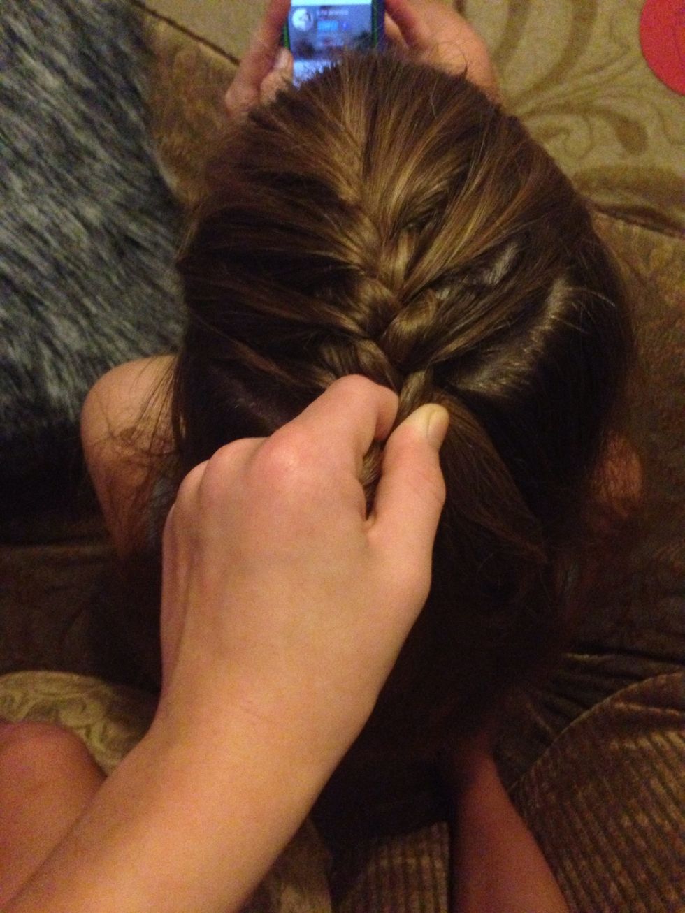 With repetition on both sides, tightening, dropping the middle strands, taking a pretty thin piece from the front of your head, you'll end up here in a couple seconds.