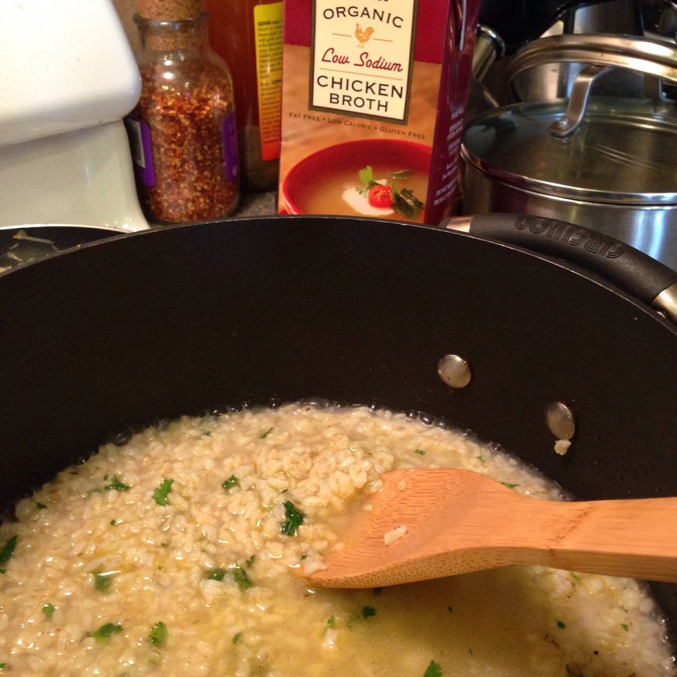 With rice nice and toasty, add 1 cup of chicken broth, stir, and bring to a simmer. Once most of the liquid is absorbed, add another cup of broth. Repeat this step until rice is cooked.