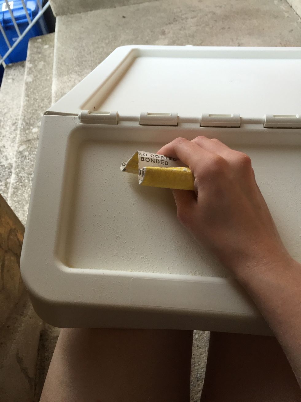 With sand paper, sand down the centre of each lid until it's no longer shiny. Wipe it down with a damp cloth to get rid of all the dust. Pat dry.