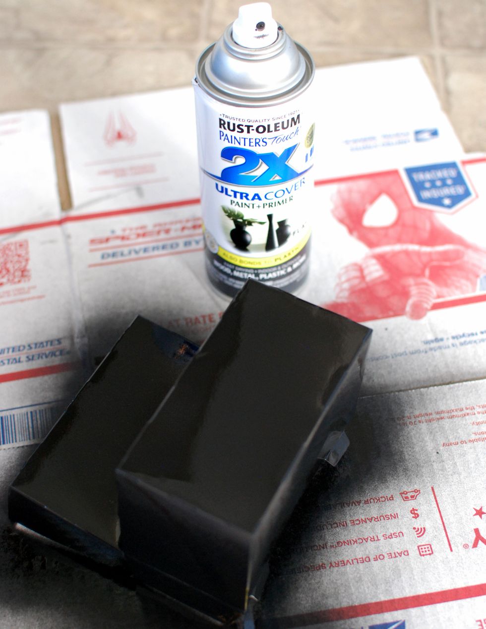 With some black spray paint, cover the box entirely. Make sure not to go over it too much, the wet paint will warp the box.