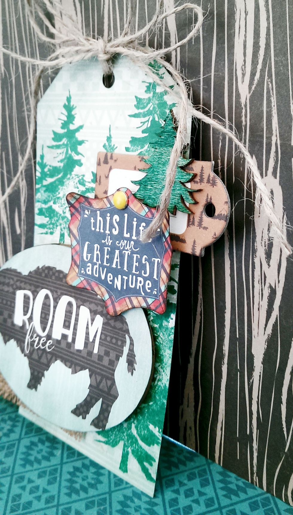 With some jute string, tie to the top of the tag.