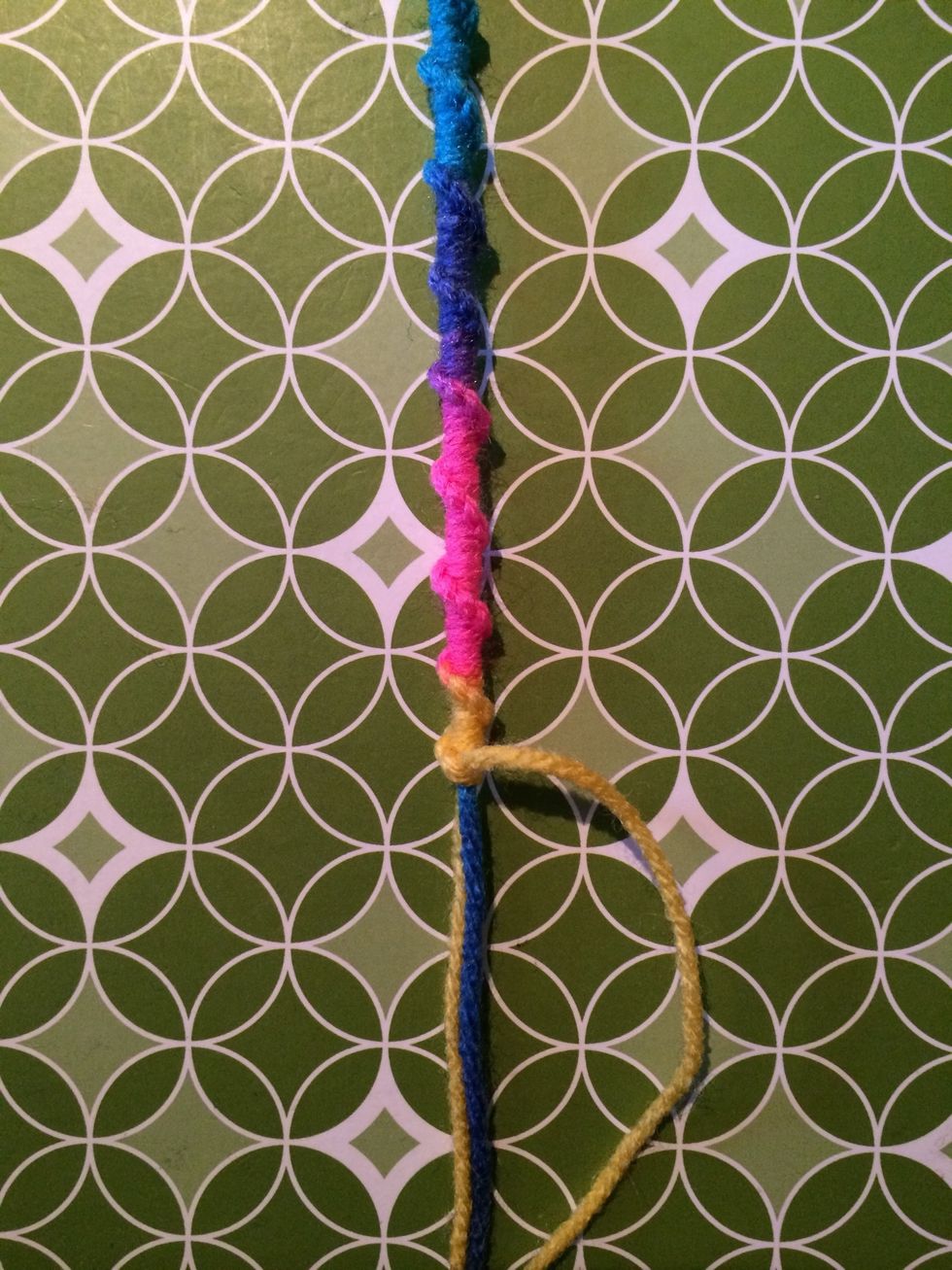 With some more knots done. At this step or anytime you can change your string and bring in another color. I used multicolored yarn so I really don't have to change strings.