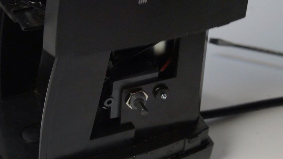 With the 4 clips released, stand grinder upright and slide case up to remove. You may need to pull case slightly to clear the shaft of on/off knob.