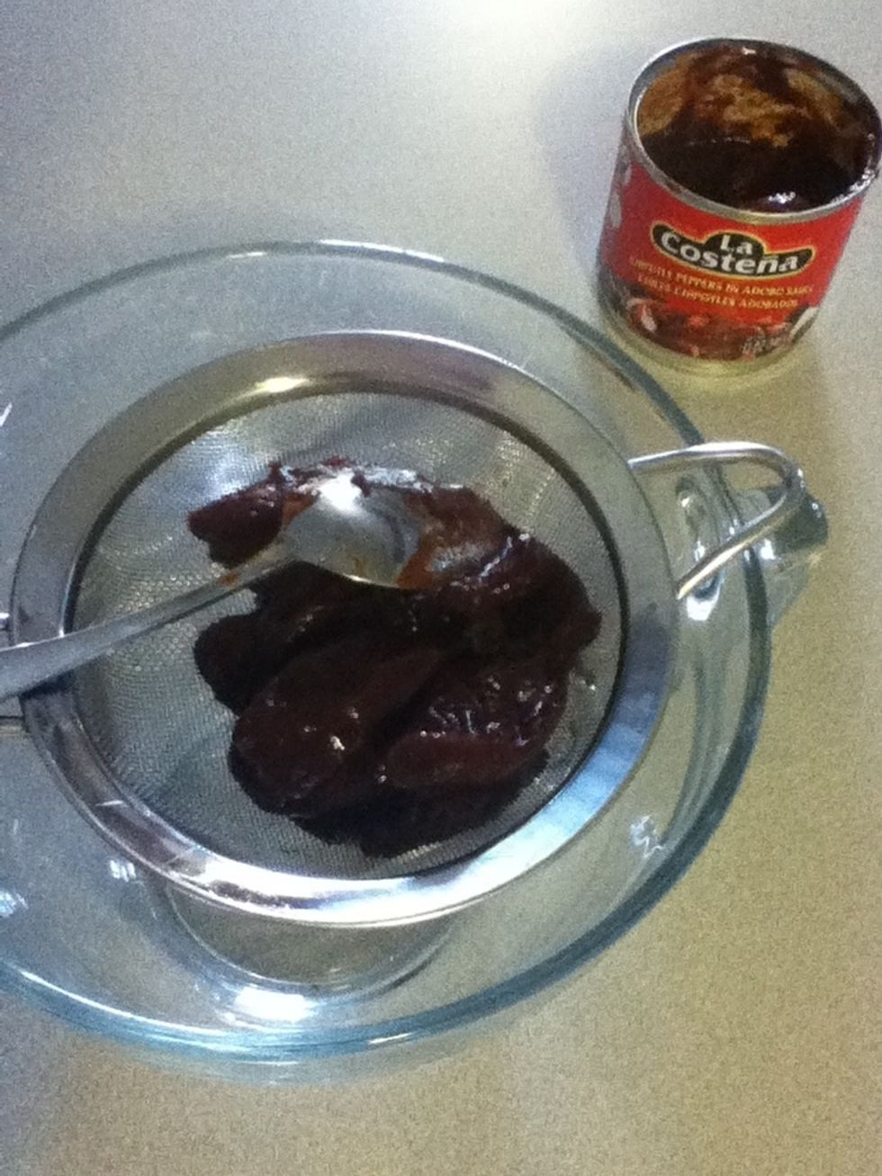 With the back of a spoon, mash some peppers and their sauce through the sieve. The contents of the bowl will then be a nice smooth chipotle pur\u00e9e suitable for your velvety potatoes.