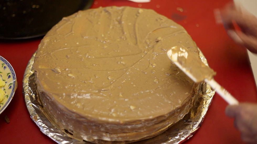 With the balance of cream cover the entire cake. Now if you do run out of cream it's ok. Squeeze the cake down and cream will ooze out the sides. We are genius right? Hahaha