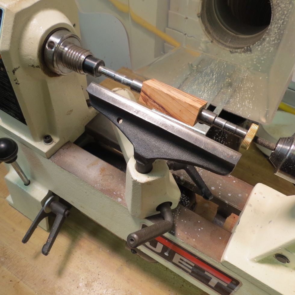 With the blank securely mounted on the mandrel, attach the mandrel to the lathe. Make sure you understand proper lathe operation and observe all safety rules. Wear safety glasses! Watch fingers!