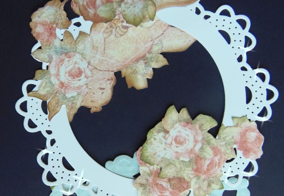 With the card opened, adhere some of the fussy cuttings to the second doily. You need to glue them in an upside down position -sounds weird, but trust me this is how it needs to be done.