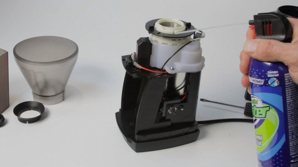 With the case off remove any debri inside the grinder housing. Canned air works well for this.