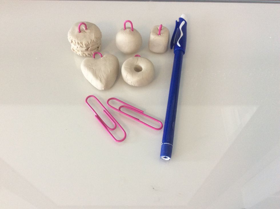 With the clay make whatever u want and stick a small paper clip through it allowing whatever u made to have a loop at the top of it. Let the clay dry and harden