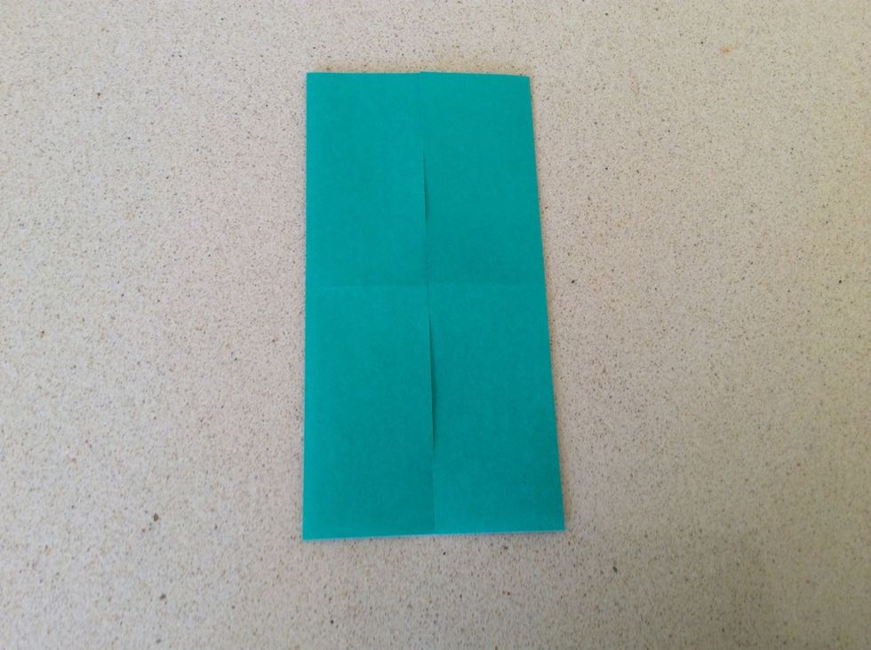With the coloured side down, fold both edges to the middle to make a door base.