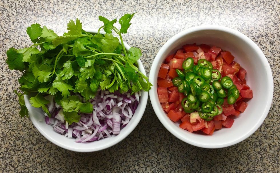 With the crab ready, chop onions, tomatoes, serrano peppers and cilantro. Keep aside for now.