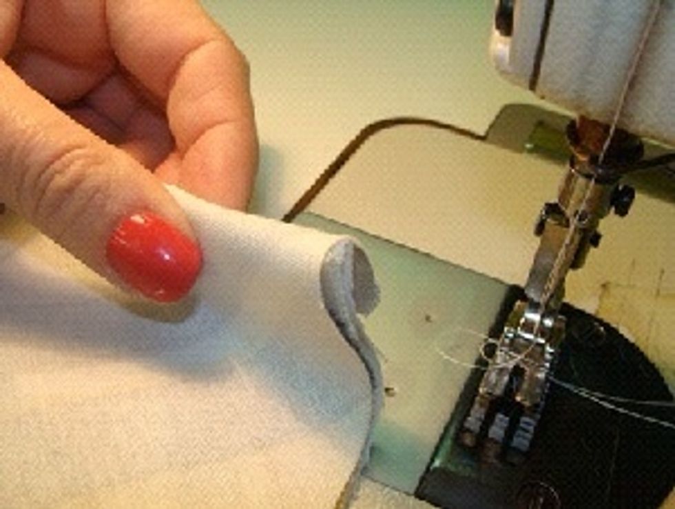 With the drapery panel face up, place the banding material even with the top edge and tuck under 1''.