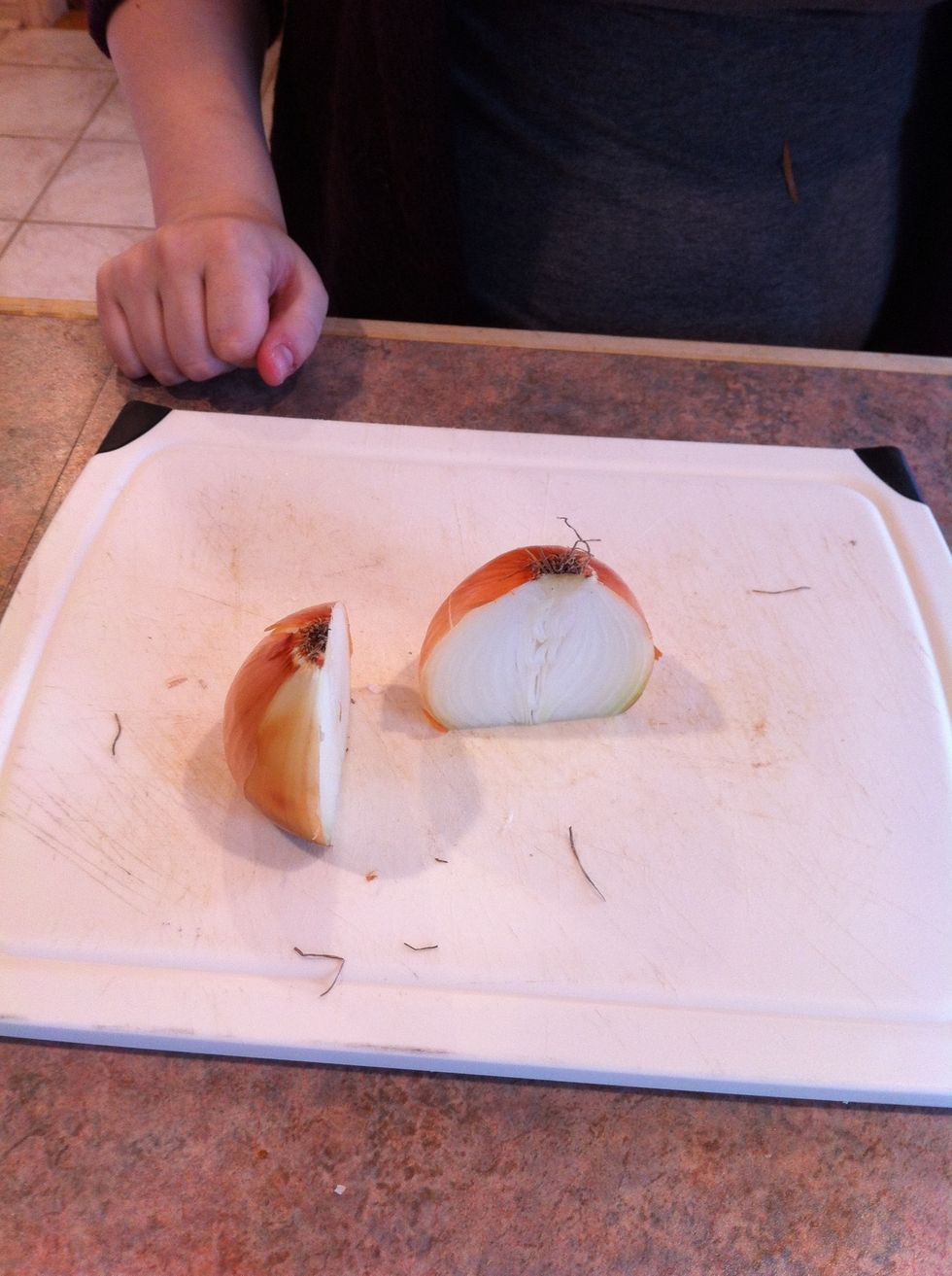 With the flat side down on your cutting board, slice the onion into two equal parts