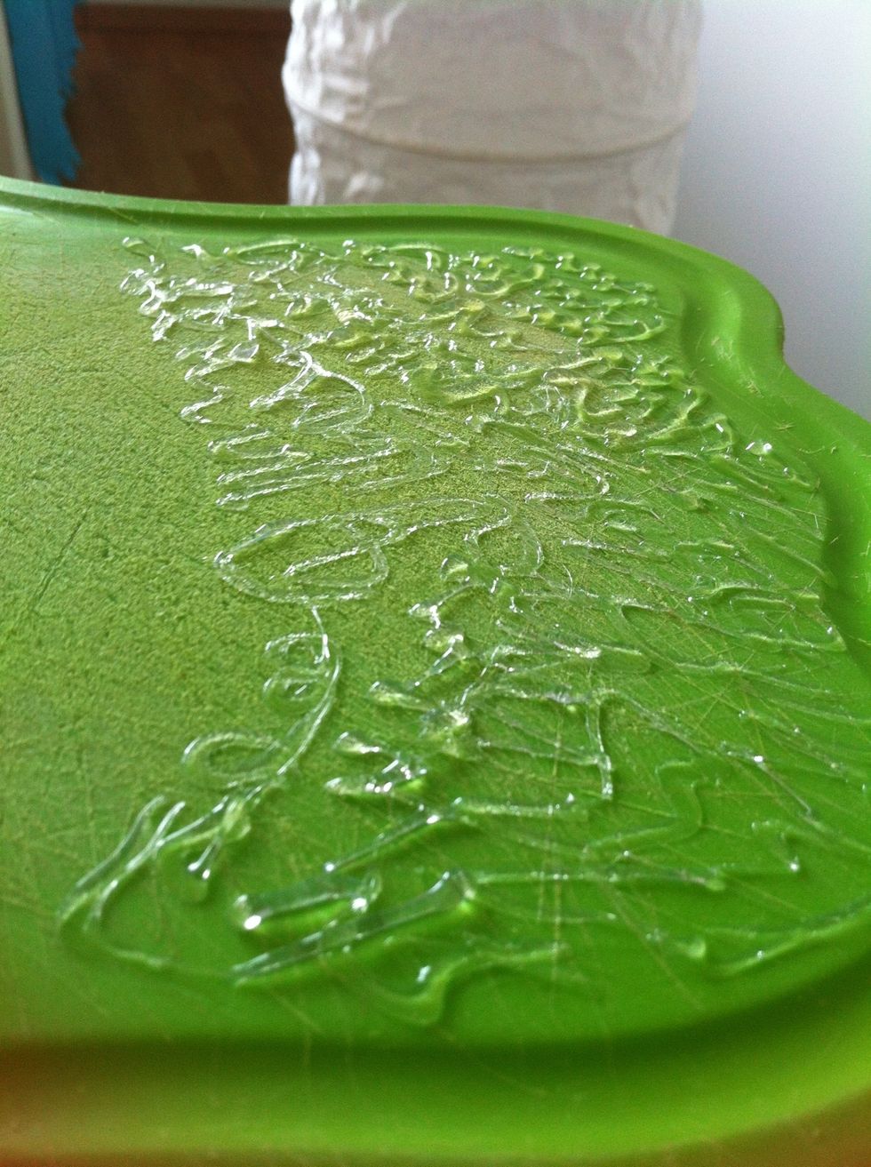 With the glue gun, start making twirly shapes on the board. Make sure they are sticking out, not to be really close to the board. Fill up the board and let it dry. You can start using it right away