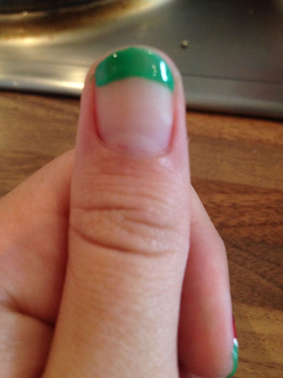 With the green paint a curve at the tip of your nail :)