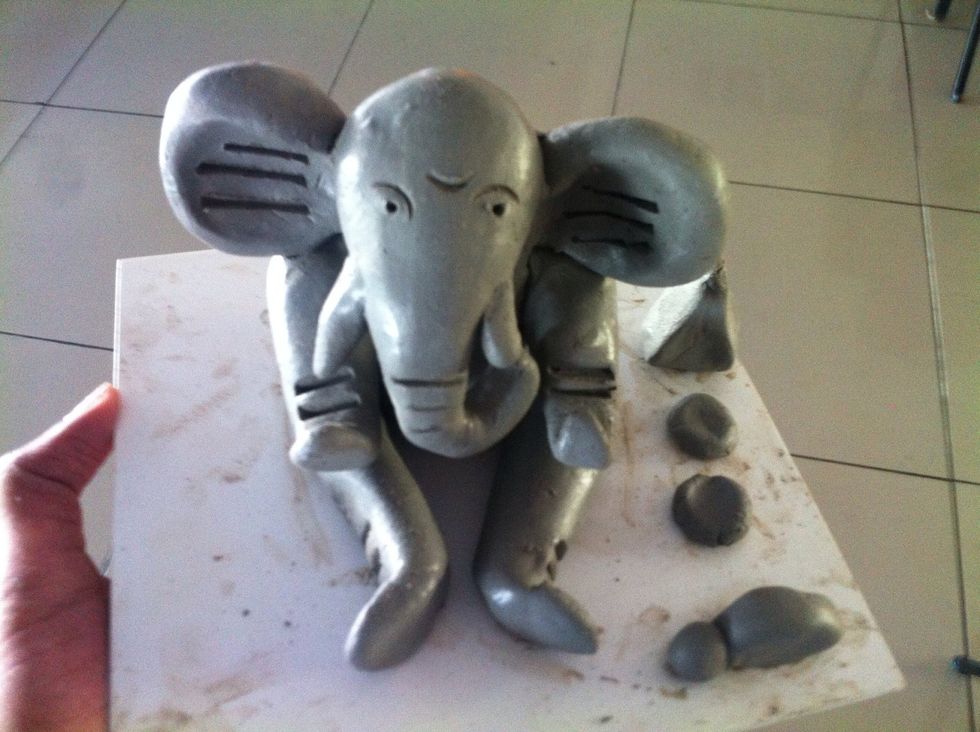 With the help of a refill or any pointed tool carve eyes and other needed design