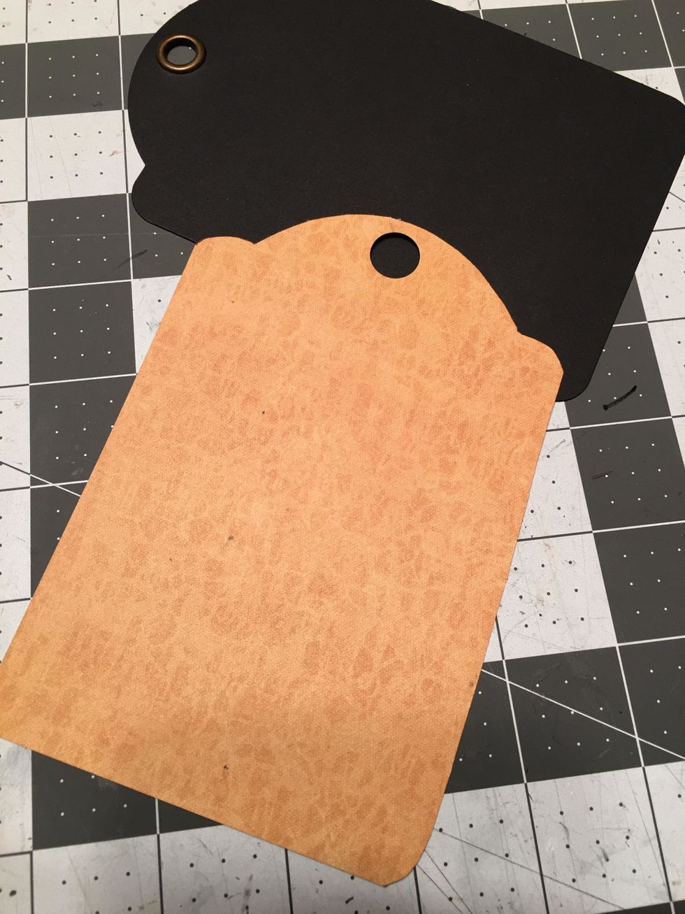 With the hole punched your paper will look like this. You will do this for all the tags of the album, front & back.