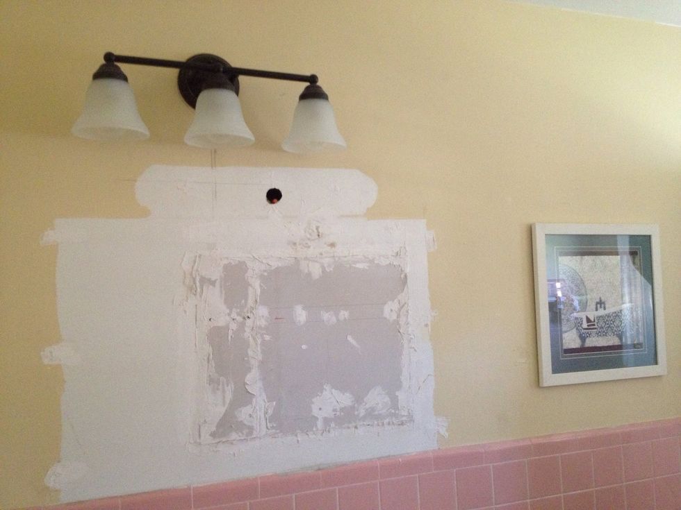 With the light fixture in the right spot, I covered the small gaps, between the sheetrock and the wall, with spackle.  After letting it dry for some time, I sanded down the surface to make it even.