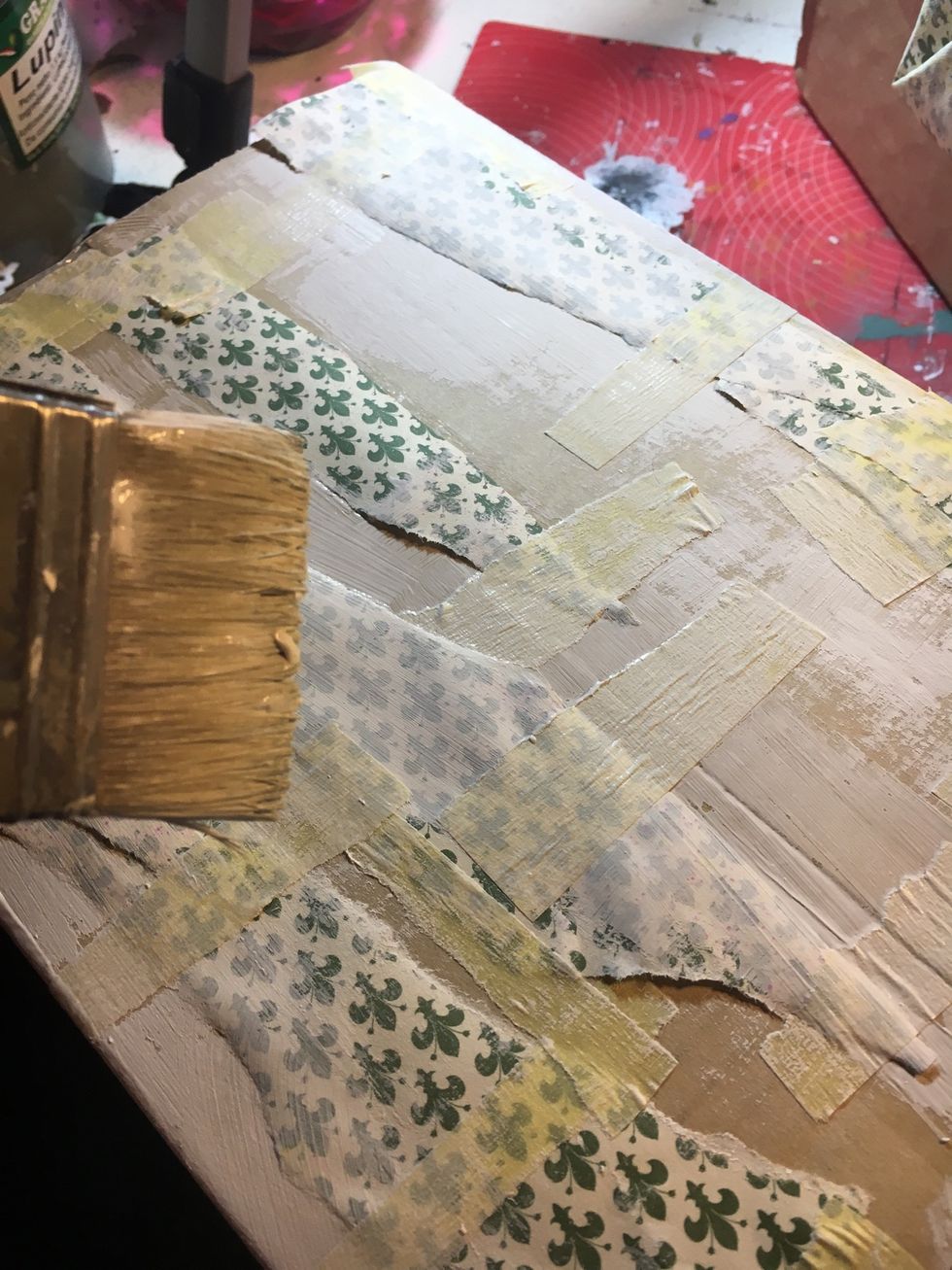 With the masking tape create a texture and cover it with white gesso