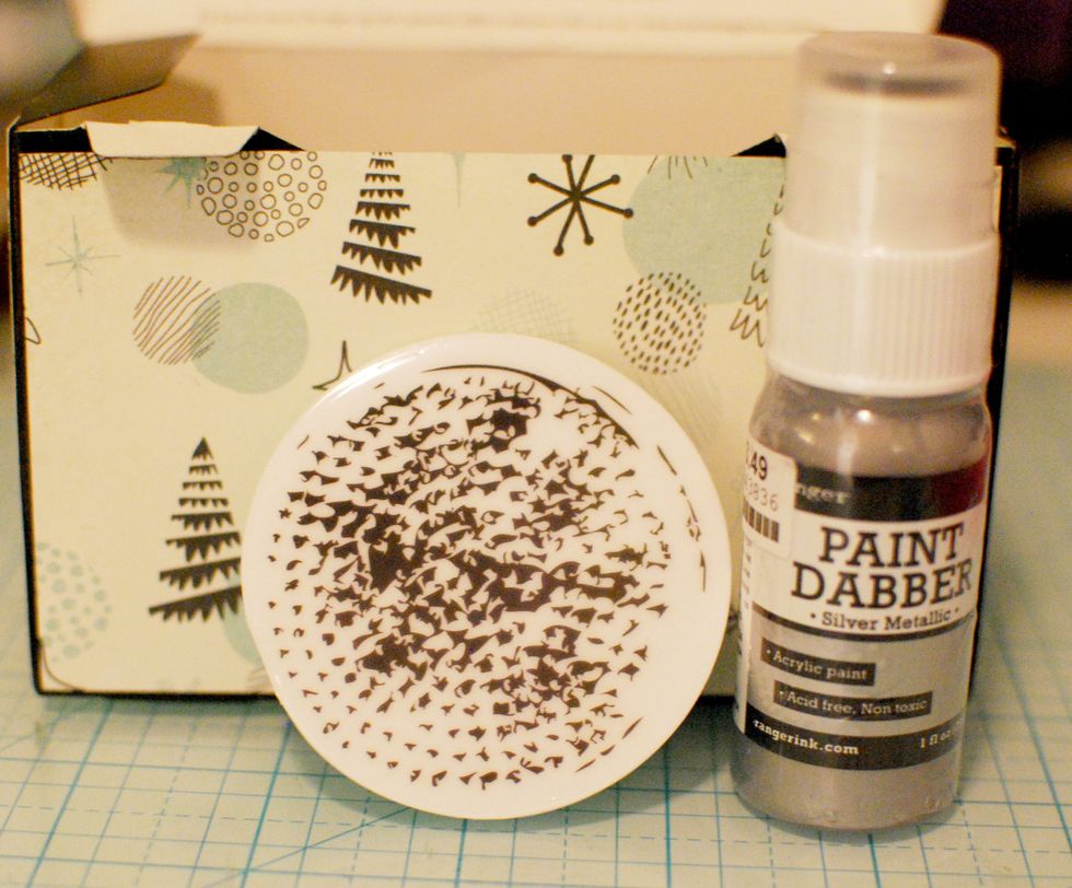 With the Metallic Silver Paint Dabber, dab color directly onto the circle stamp. Stamp a few random places on the box.