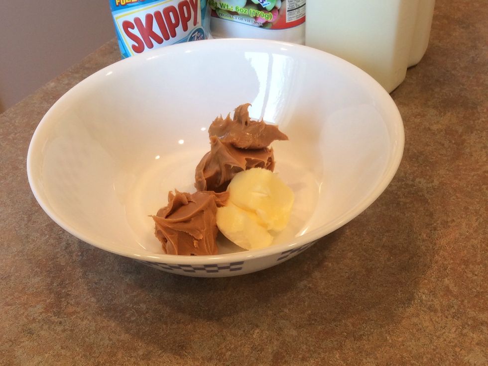 With the mixer, combine the 1/4 cup of softened butter with the peanut butter in a large bowl
