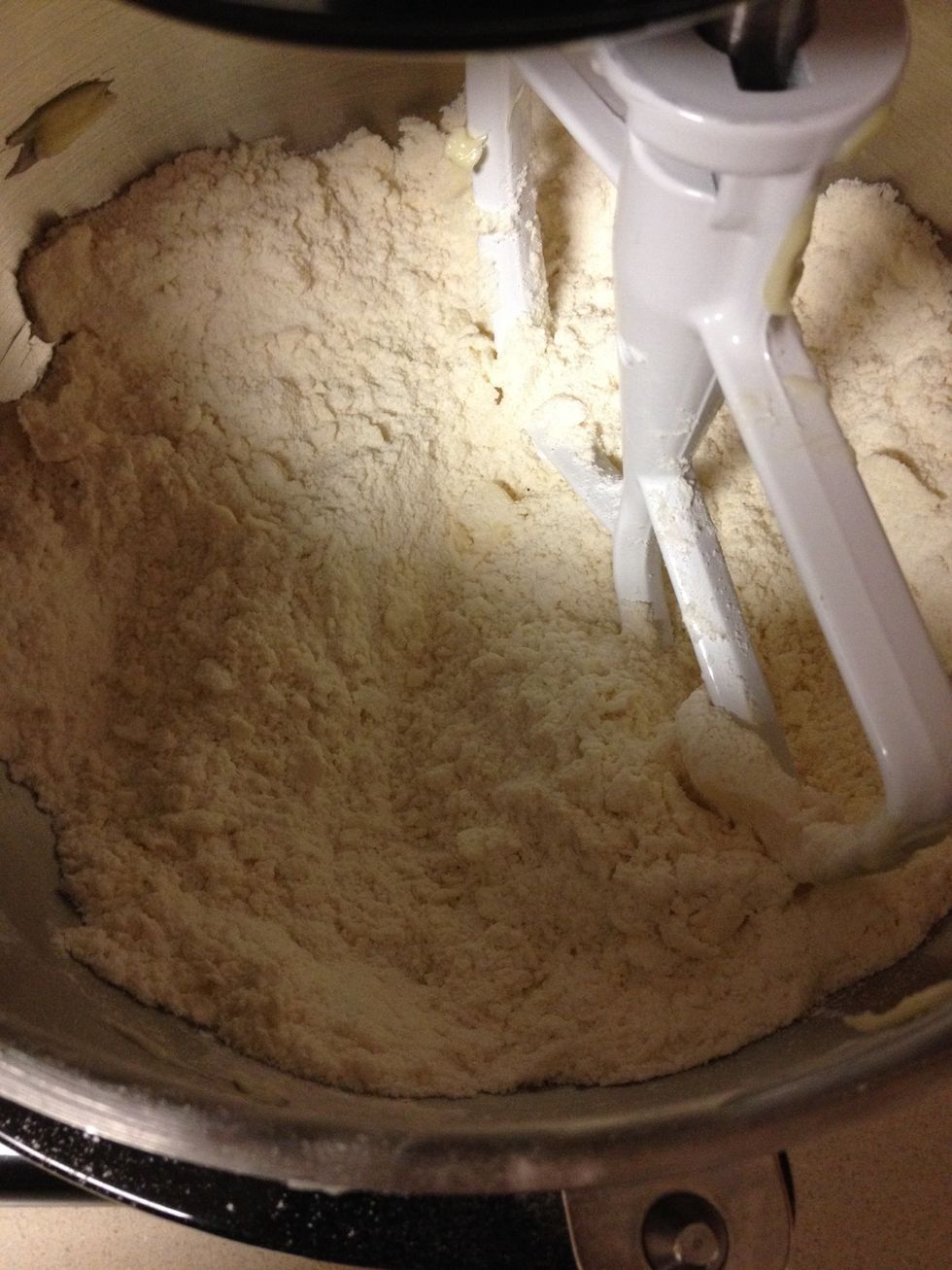 With the mixer on low, slowly add the softened butter.  Once the mixture looks like this, add the milk in a slow, steady stream.