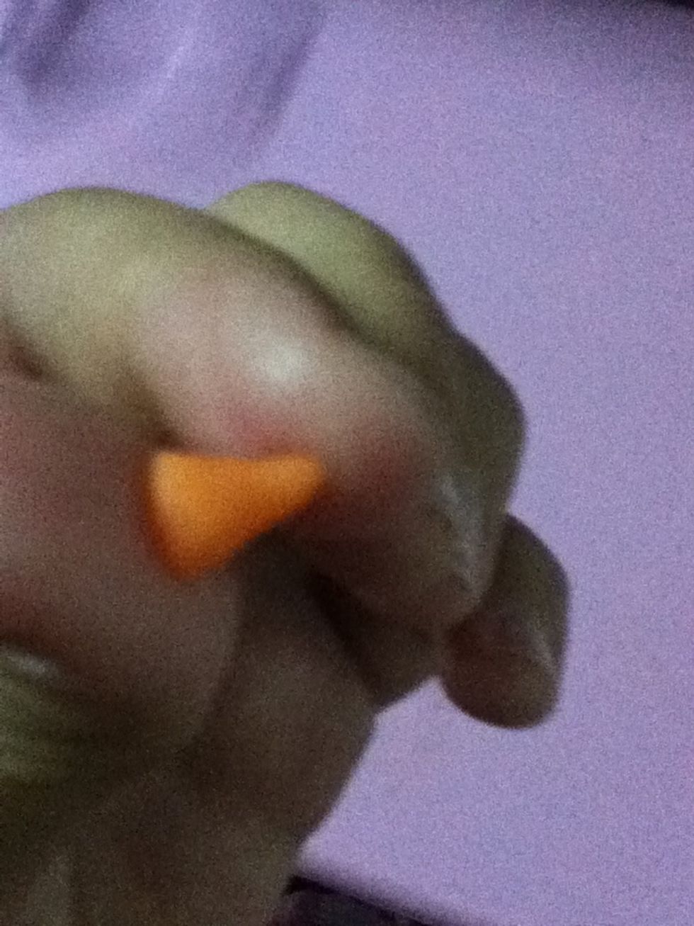 With the orange clay make triangle (it's the nose)