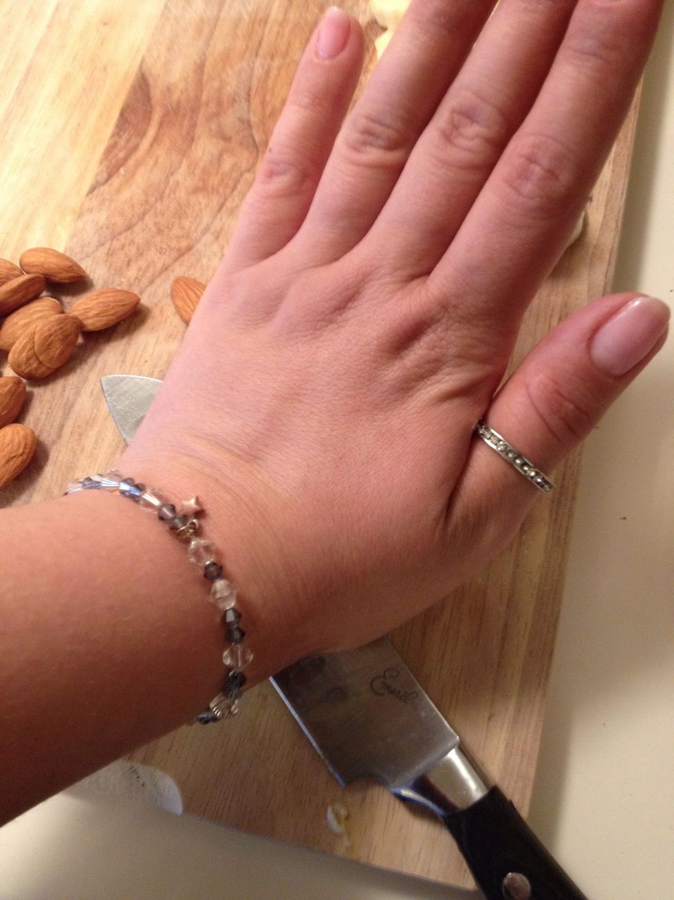 With the palm of your hand press down to crush the almond. *please be careful*