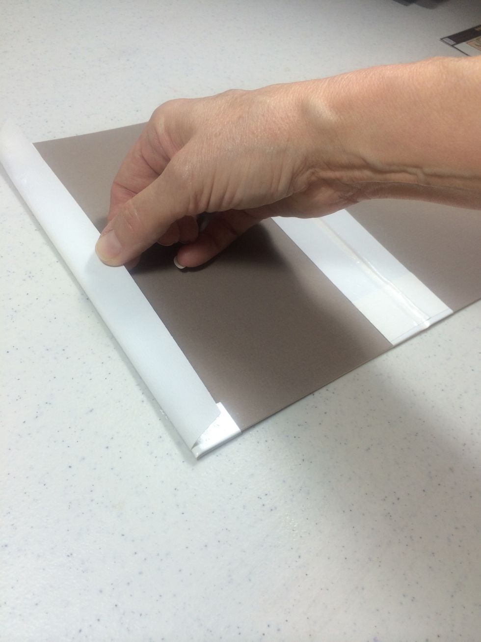 With the panel still folded in, wrap the remainder of tape around to the back. Doing this while the panel is folded will allow it to open and close easily.