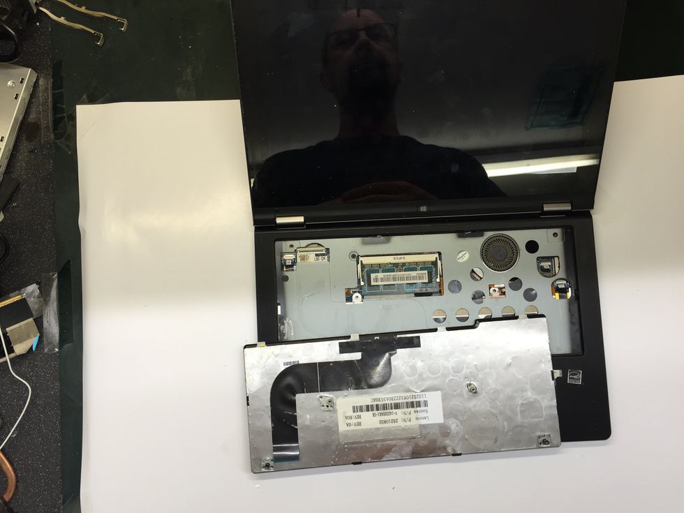 With the ribbon cable disconnected the keyboard is now fully removed from the chassis. Reverse these steps to fit your new keyboard.