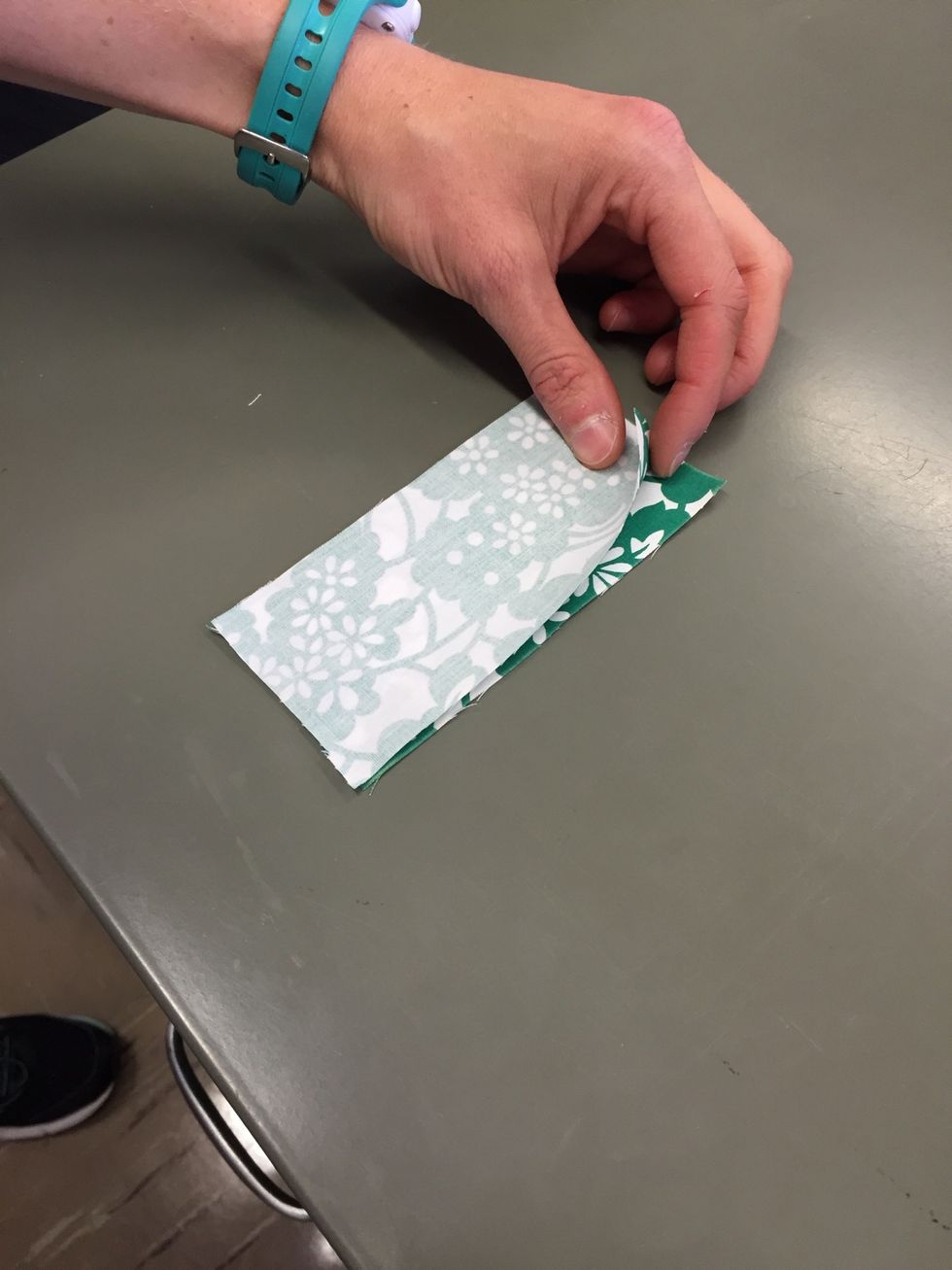 With the RIGHT SIDES of the fabric TOGETHER, line up the edges of the fabric.