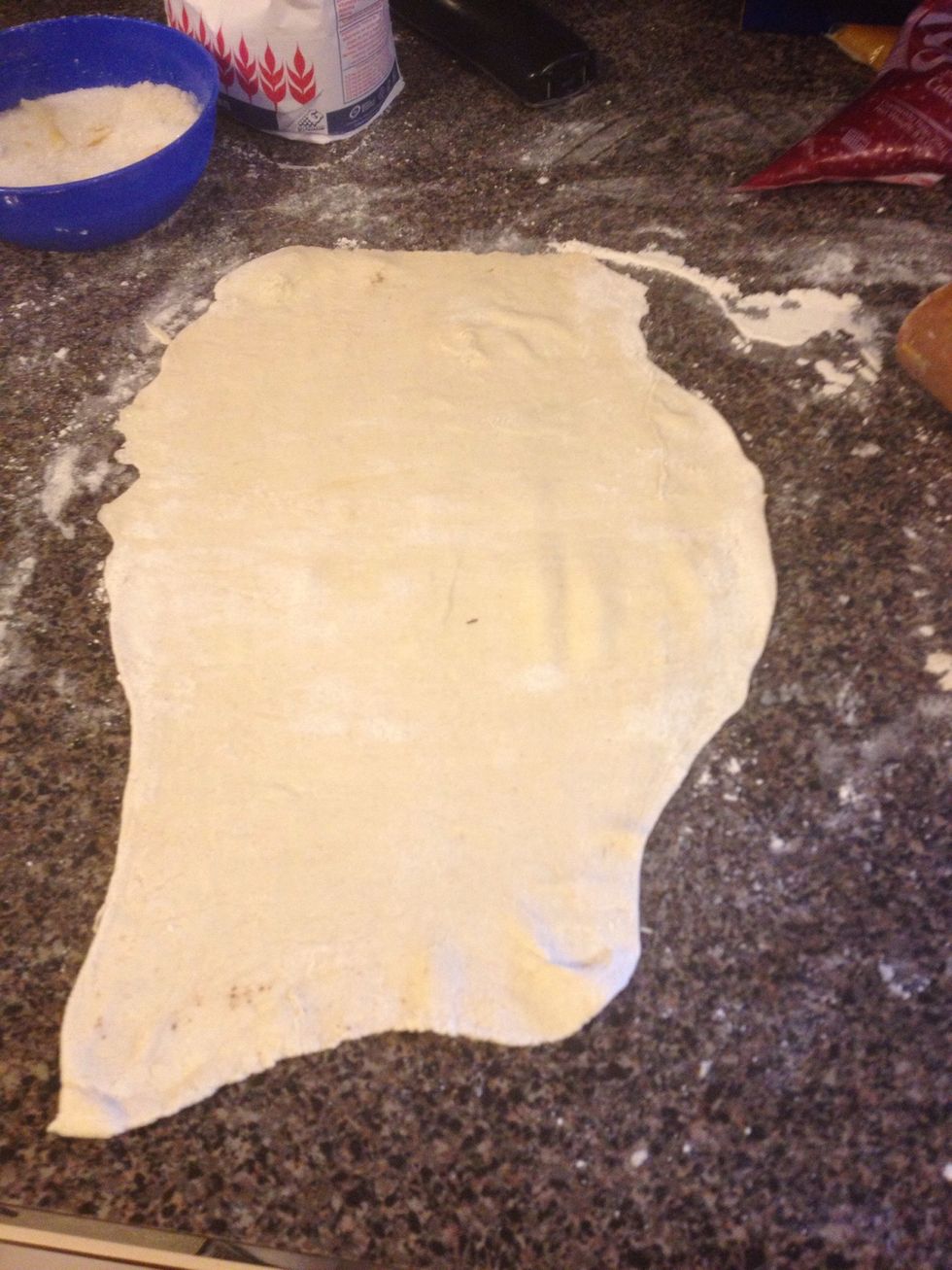 With the rolling pin, roll the dough as thin as you can. Do this on both sides so it will be thinner.