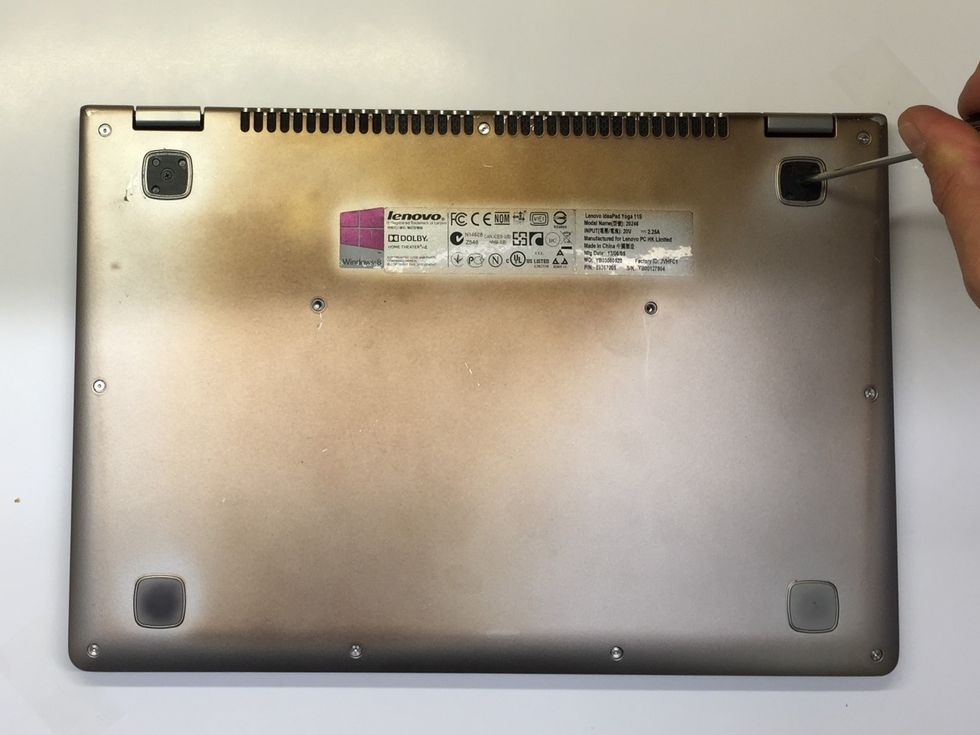 With the rubber feet removed we can now see the two black crosshead screws. Remove these with the crosshead screwdriver and carefully set them aside.