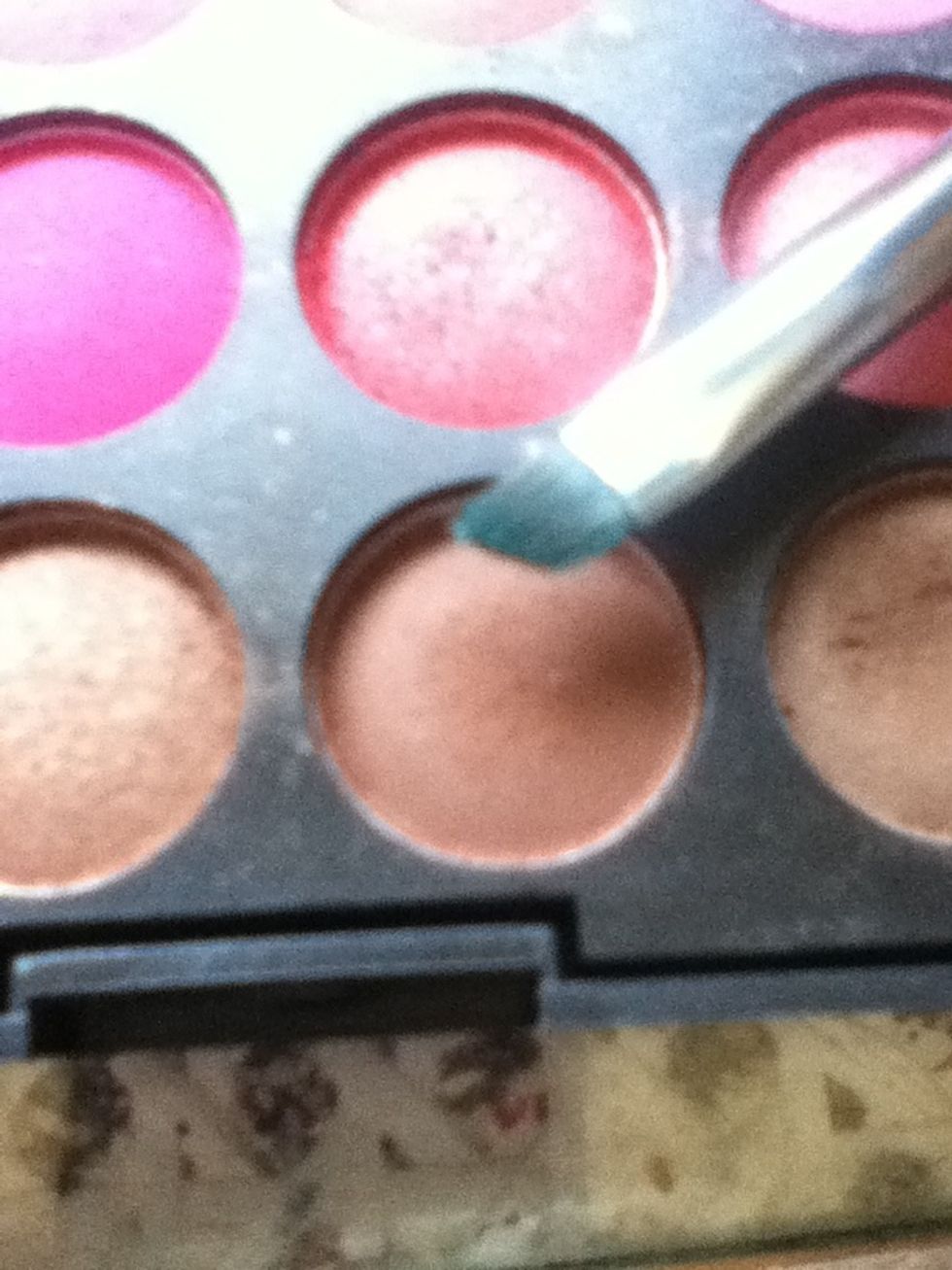 With the same brush take some brown eyeshadow.