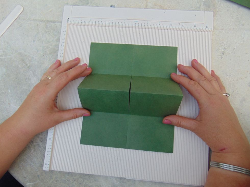 With the short sides at the top and bottom start to bring the centre fold up....