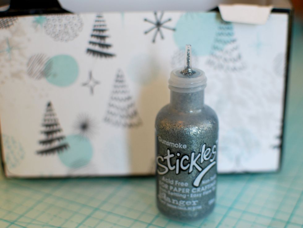 With the Silver Stickles Glitter, outline a few stars and dots on the paper print. Set aside to dry.