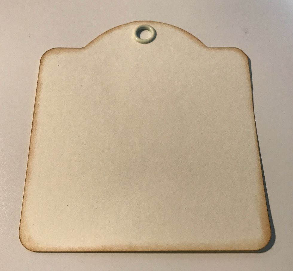 With the Square Ivory Tag out of the package. Ink the edges of the tag using Vintage Photo Distress Ink and a blending tool with foam.