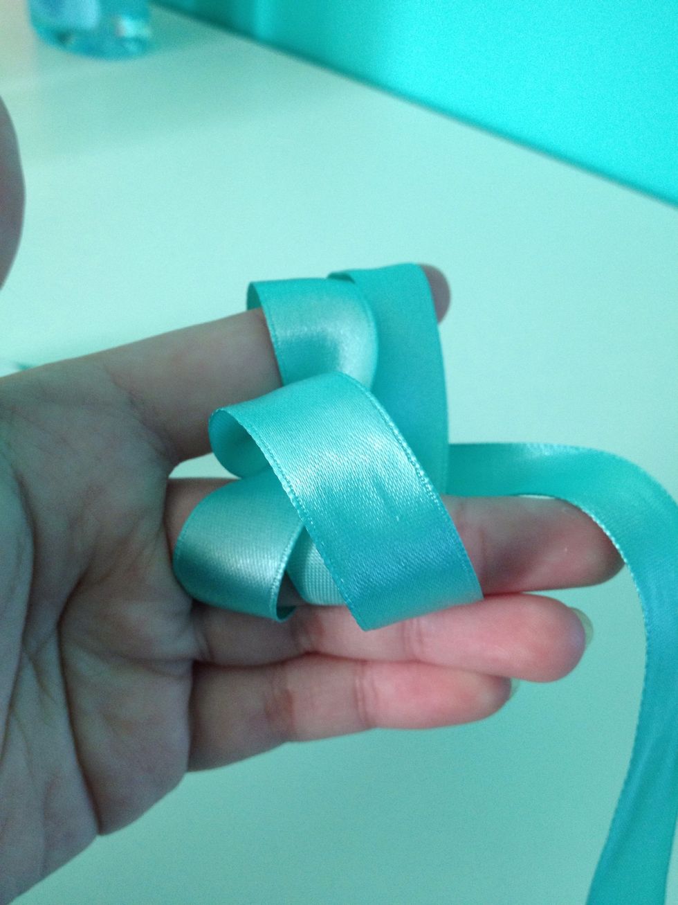 With the strand you have just weaved, pull it out SLIGHTLY, just so it creates a small loop like so.