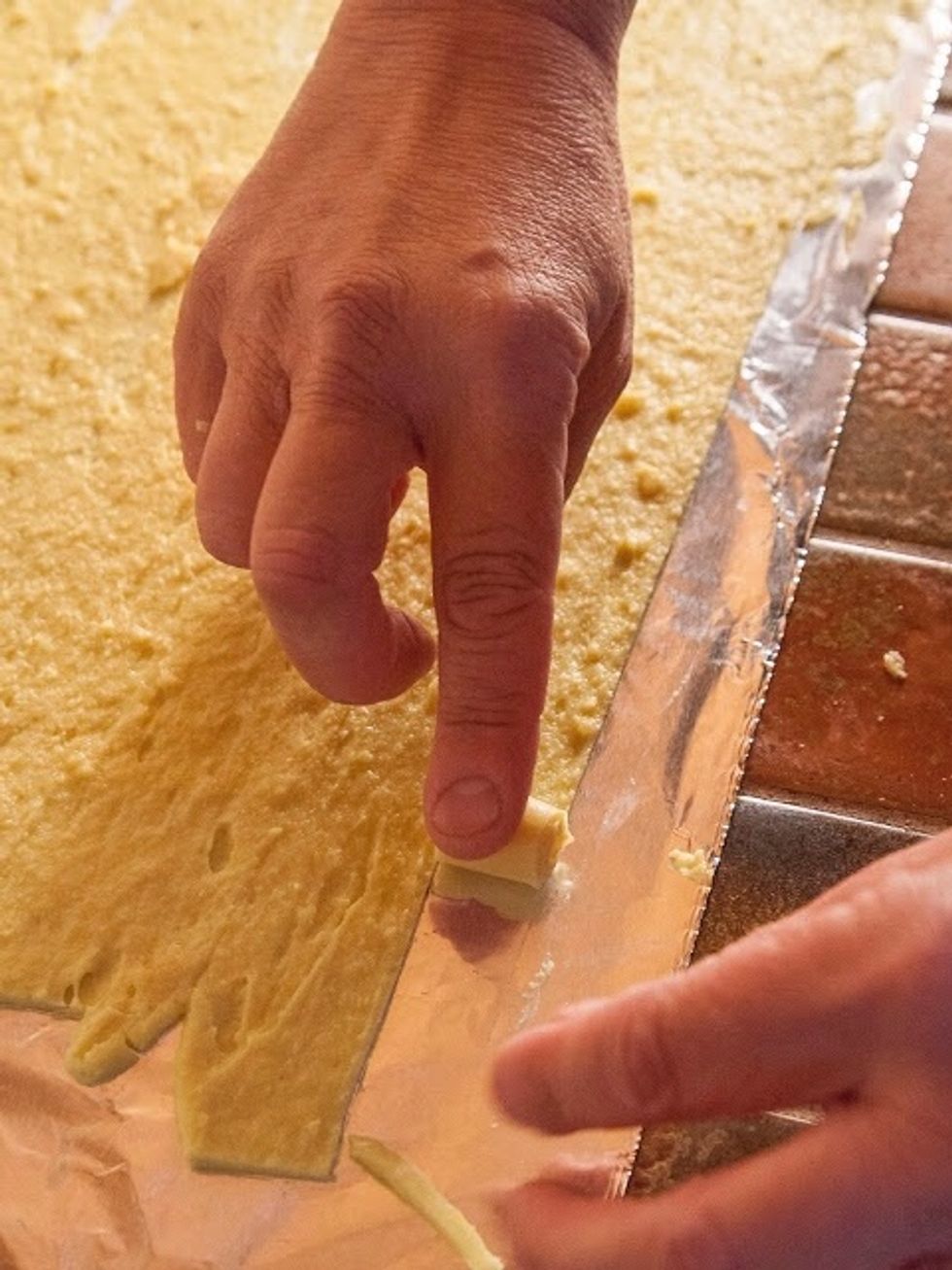 With the tip of your knife lift up the top edge of the strip and start rolling, gently.