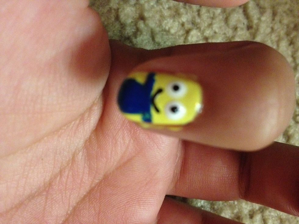 With the toothpick add a smiley face and the two black dots as the pupil