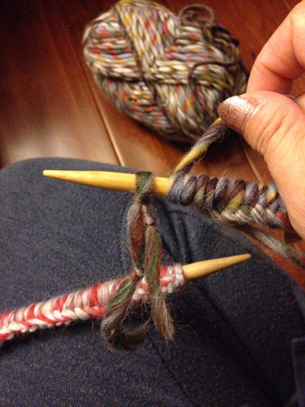 With the working yarn on the right side, place a marker on the right needle to signify the beginning of the round. In this case I just tied a piece of yarn as my marker.