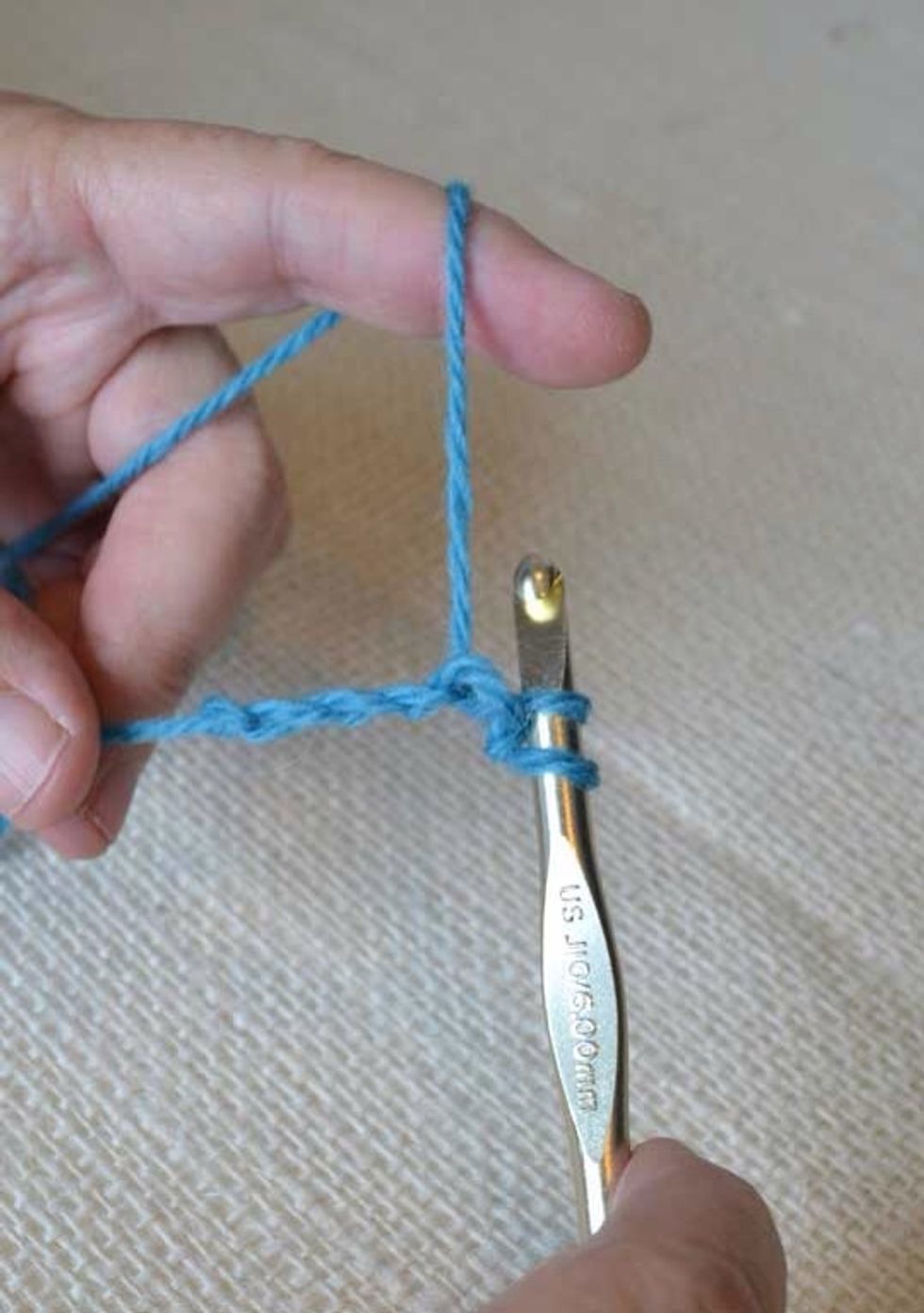 With two loops on the hook, yarn over and draw the yarn through both loops.